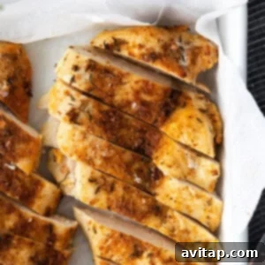 A perfectly cooked, golden-brown chicken breast in a dish, glistening and ready to be enjoyed.
