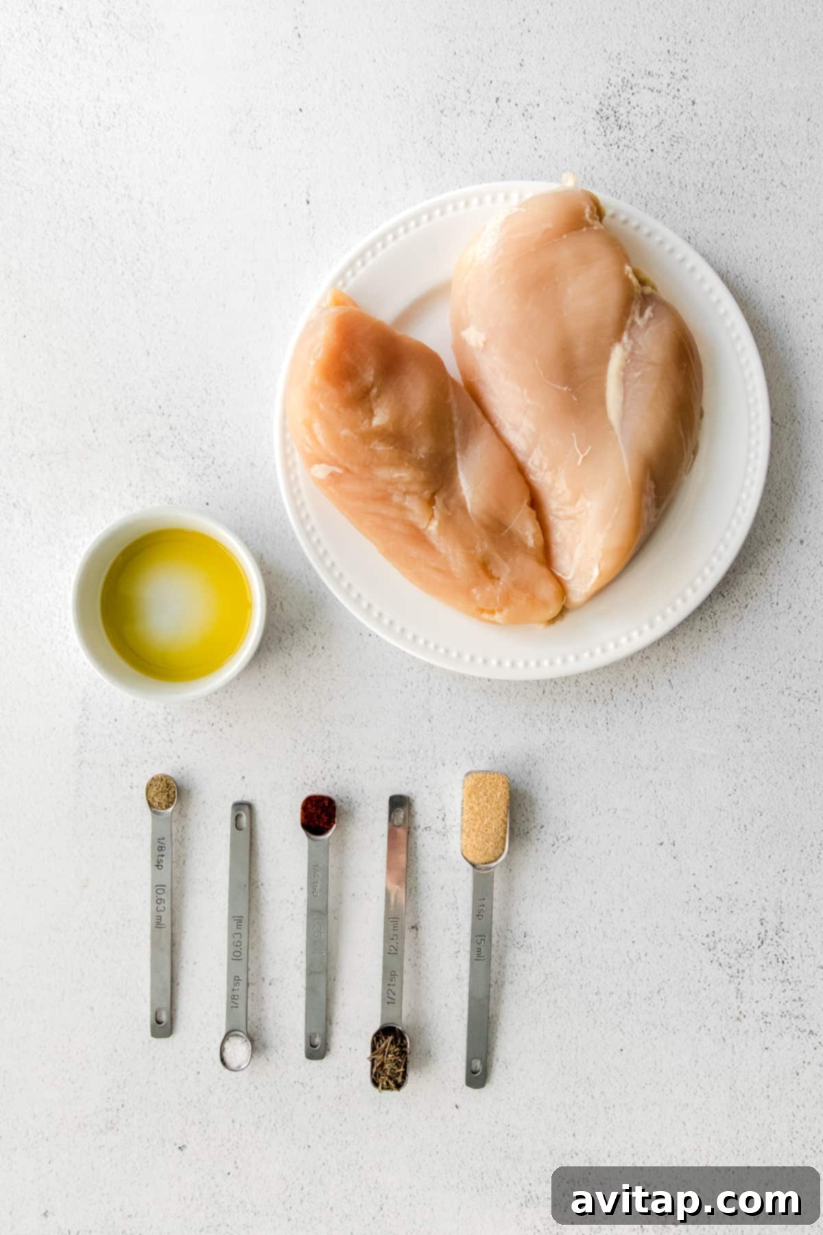 Fresh ingredients laid out on a kitchen countertop, ready for air fryer chicken breast preparation.