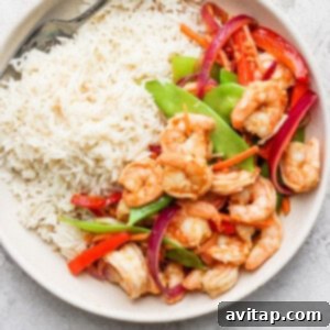 Delicious shrimp stir fry served in a bowl, garnished and ready to eat.