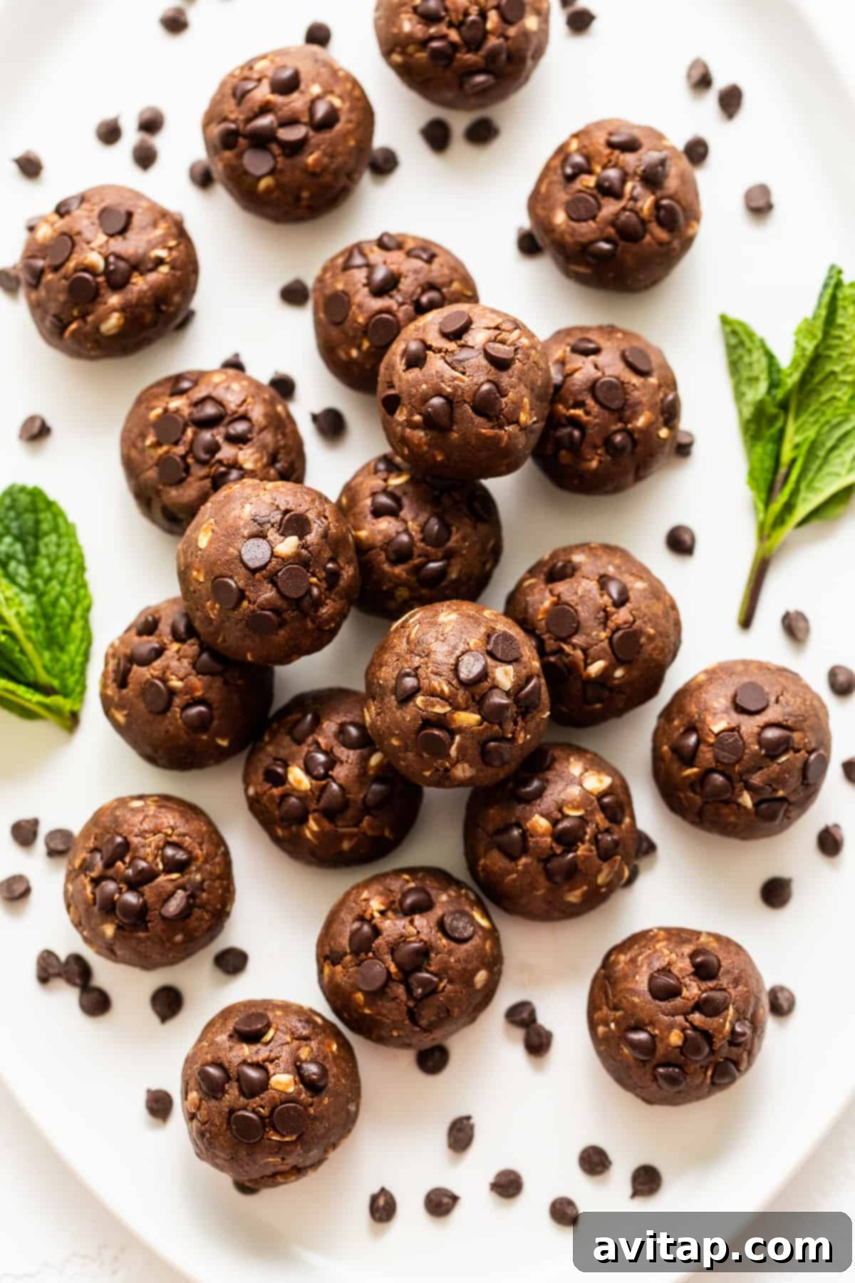 A beautiful display of Mint Chip Protein Balls on a serving platter, garnished with fresh mint leaves.