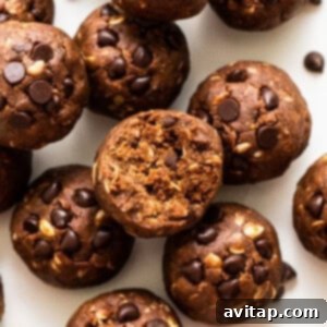 Delicious Mint Chip Protein Balls on a white plate, garnished with fresh mint.