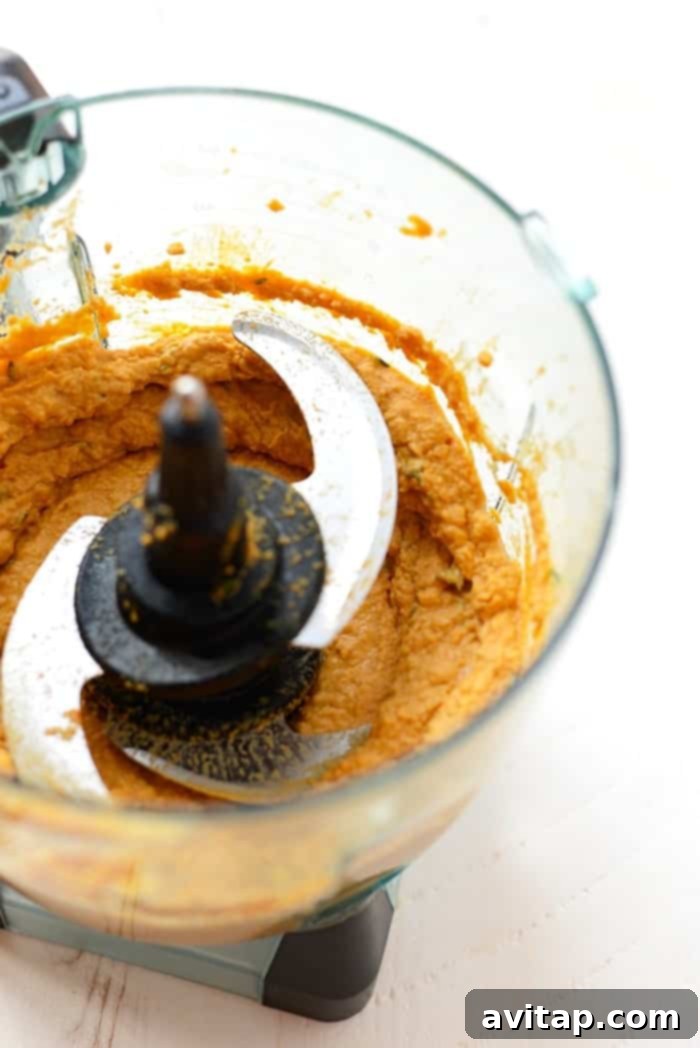 Homemade Sweet Potato Hummus: Easy Food Processor Recipe Sweet potato hummus being blended in a food processor, illustrating the ease of preparation for this homemade recipe.