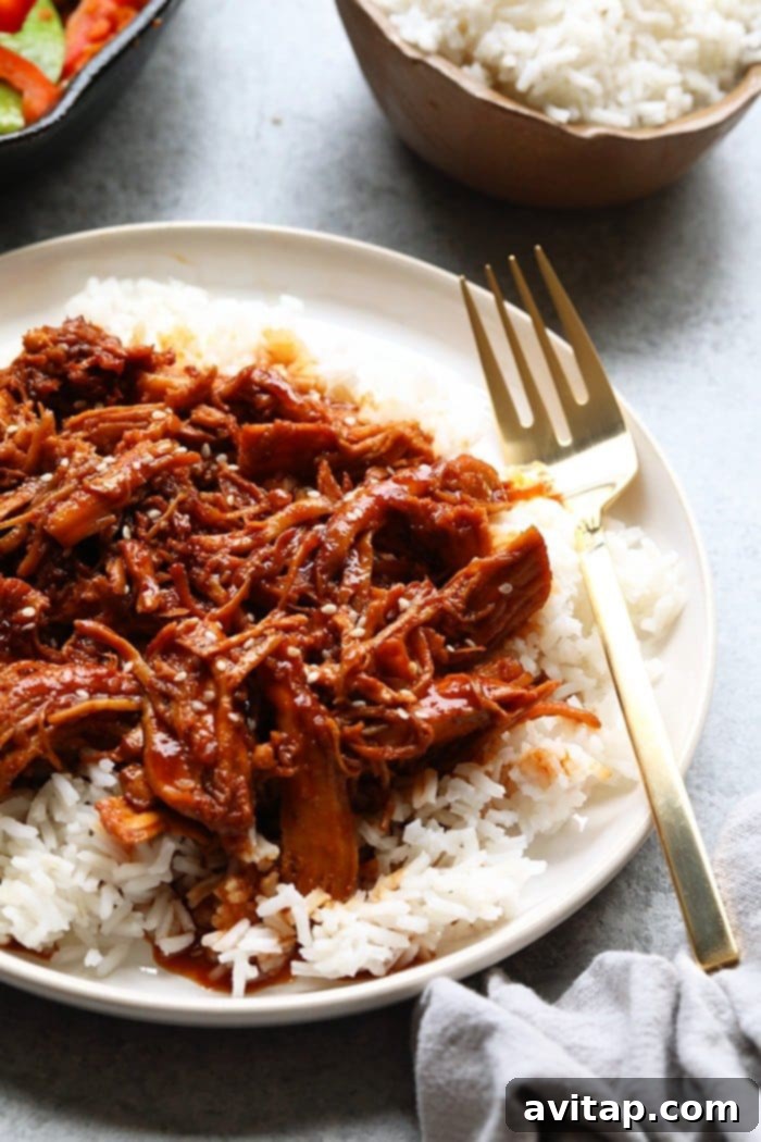 Honey Sriracha Slow Cooker Chicken, perfectly shredded and saucy, close up
