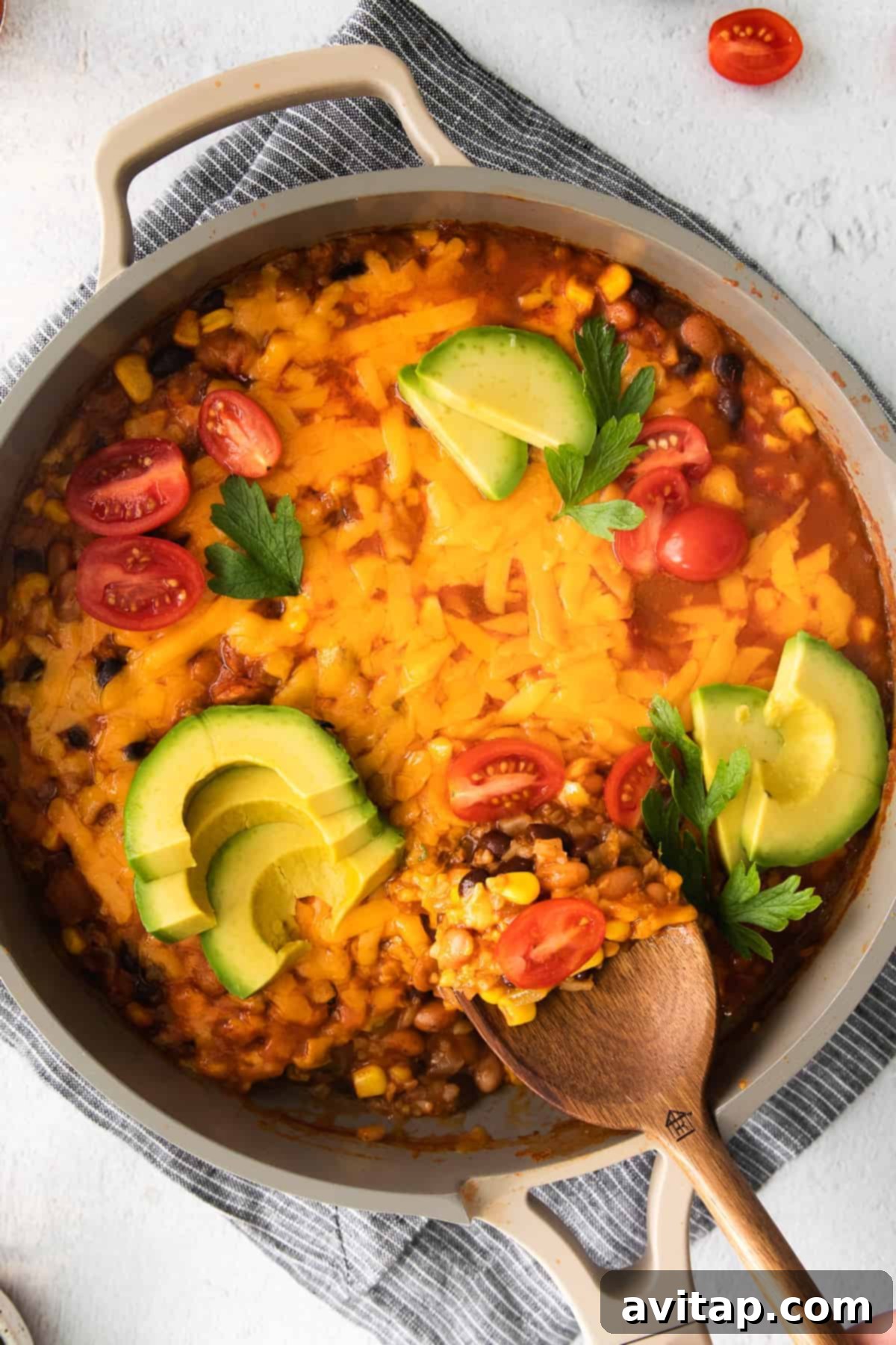 A colorful one-pan cauliflower taco skillet generously topped with fresh cilantro and lime wedges, ready to serve.