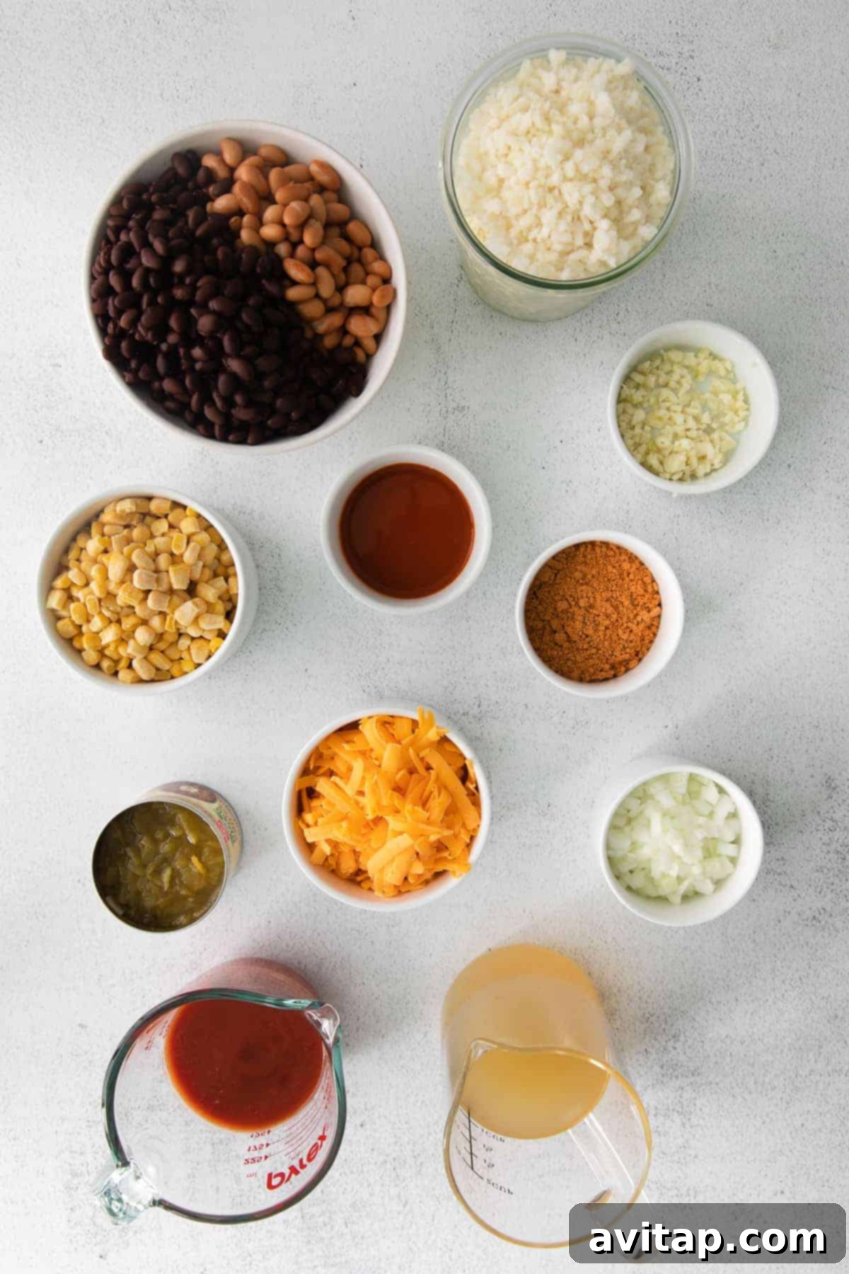Assorted fresh and canned ingredients neatly arranged on a kitchen counter, ready for the cauliflower taco skillet preparation.