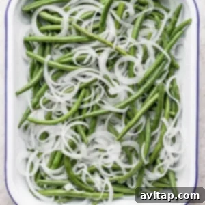 Green beans with onions in a white dish.