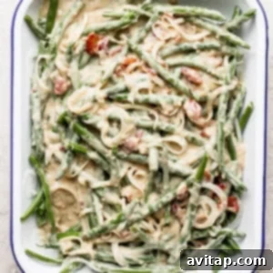 A dish with green beans and bacon in it.