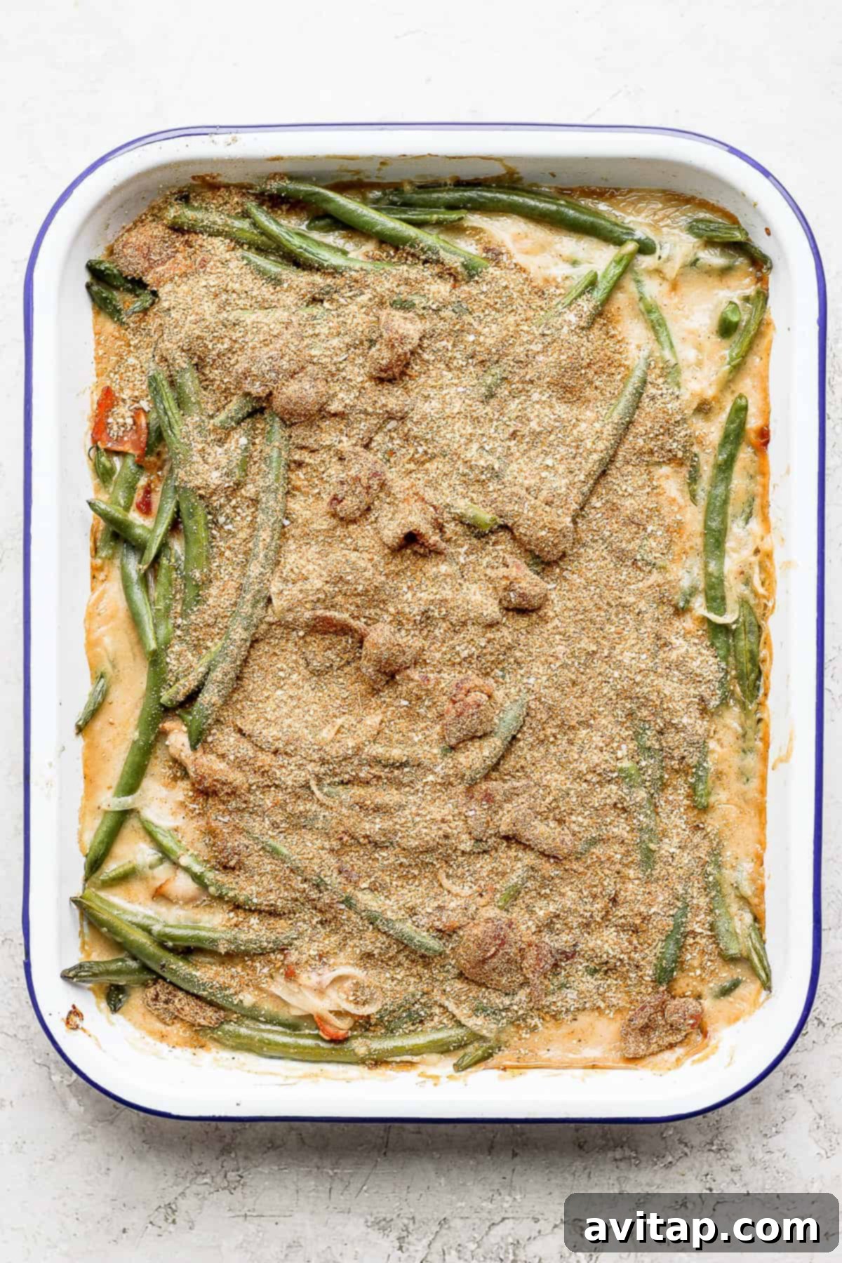 Green bean casserole with bacon and a crispy breadcrumb topping, freshly baked and ready to be served.