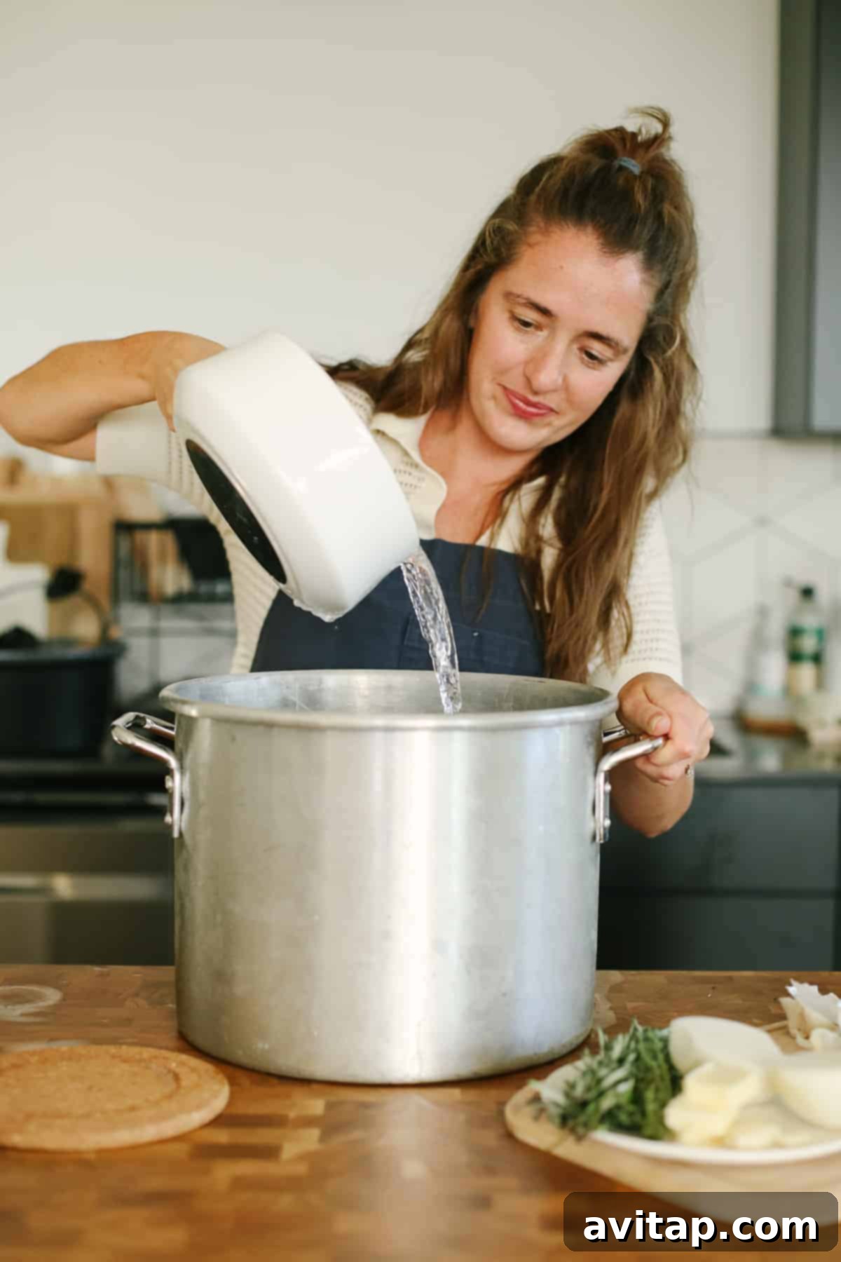 The Ultimate Smoked Turkey Brine 8 Pouring water into a huge pot.