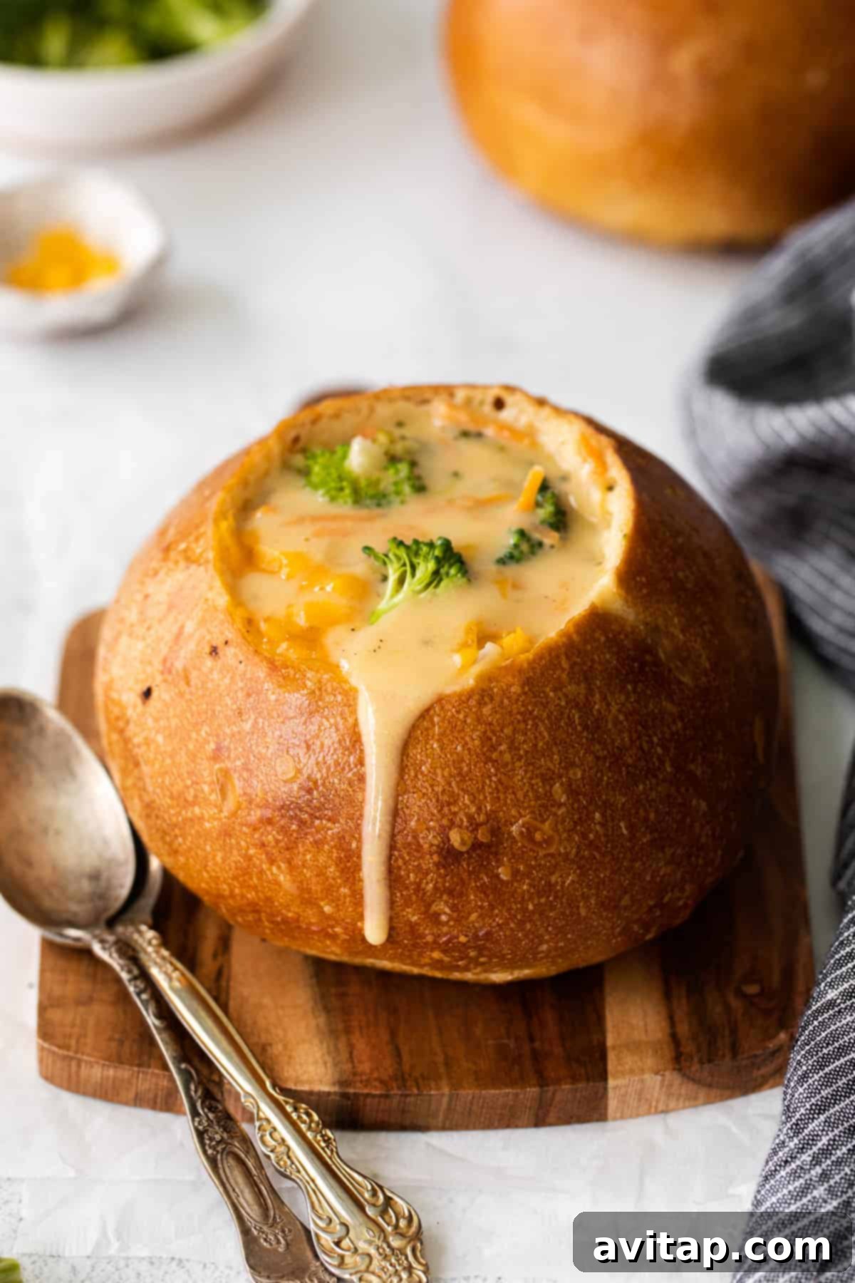 Broccoli Cheddar Soup served in a classic bread bowl, ready to be enjoyed.