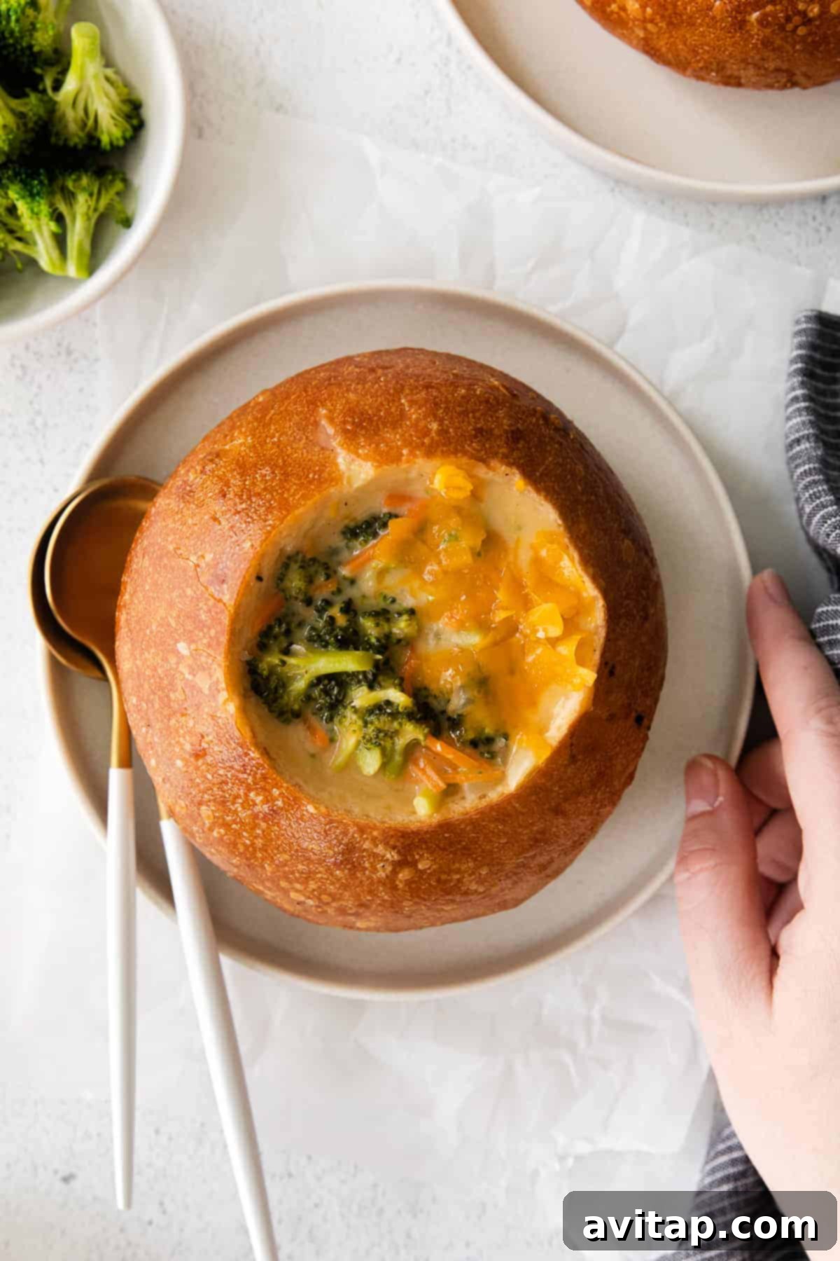 A close-up shot of the creamy broccoli cheddar soup, showing off its rich texture and tender broccoli pieces.