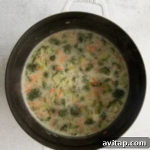 The soup simmering in the pot after milk has been added.