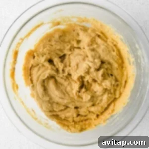 peanut butter in a bowl on a white background.