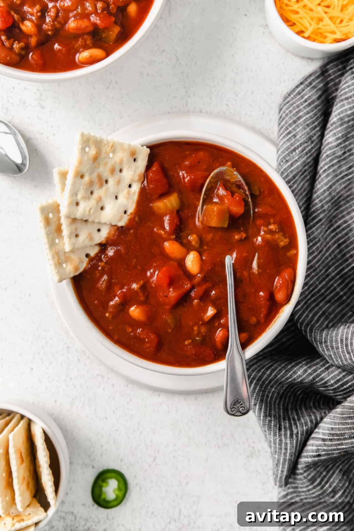 A hearty bowl of homemade Wendy's chili, garnished with crackers, ready to be enjoyed.