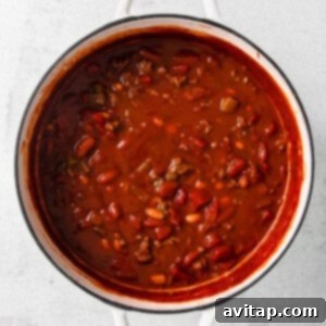chili in a white pot on a white background.