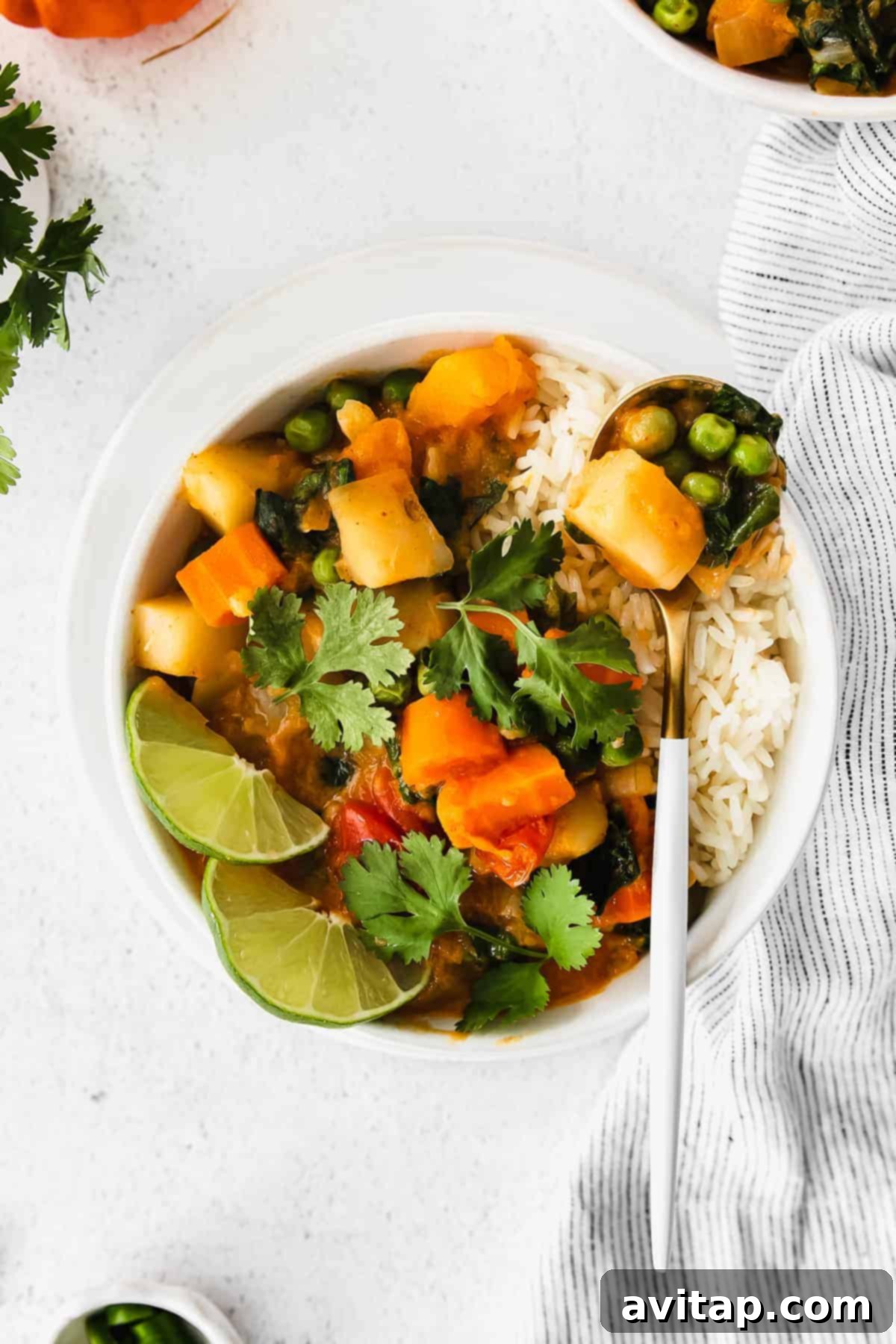 A vibrant bowl of creamy Instant Pot Pumpkin Curry, garnished with fresh herbs, ready to be served.