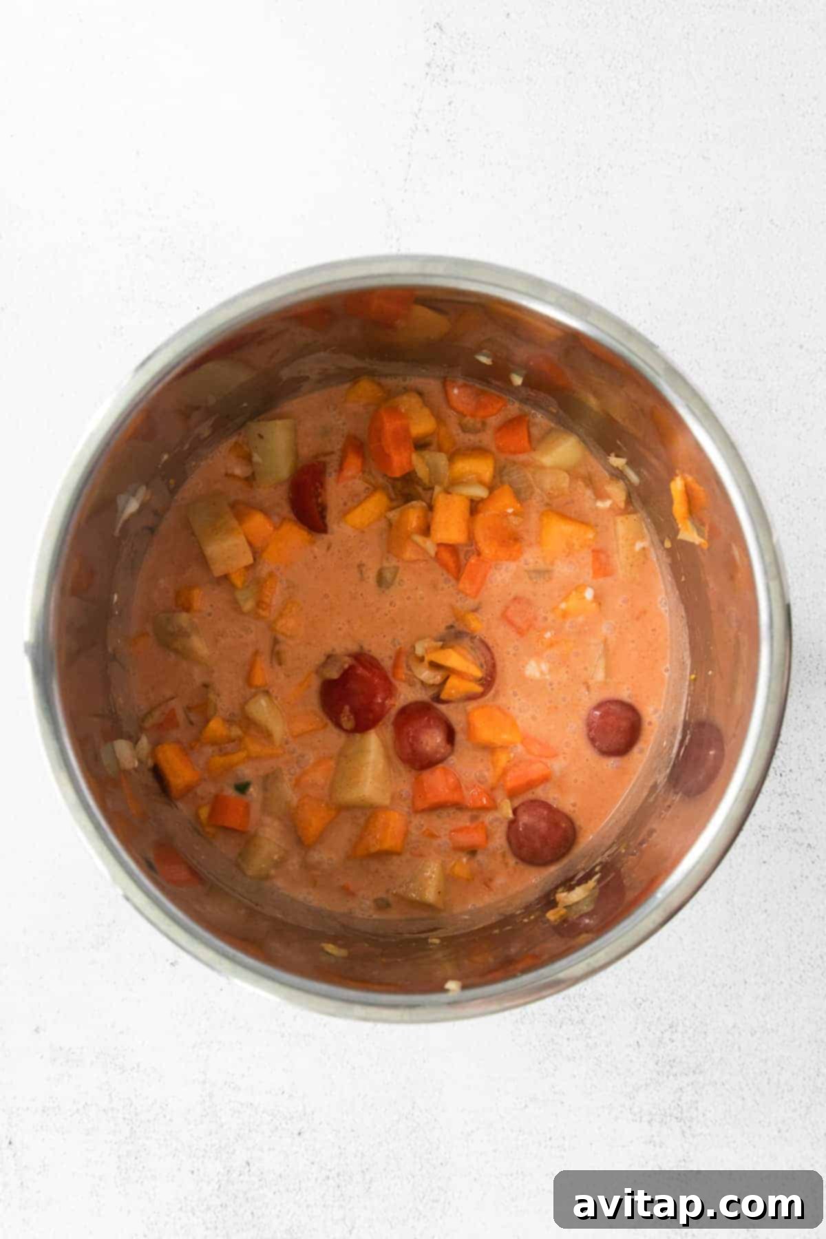 Creamy Thai pumpkin curry simmering inside an Instant Pot, showcasing its rich texture and vibrant colors.