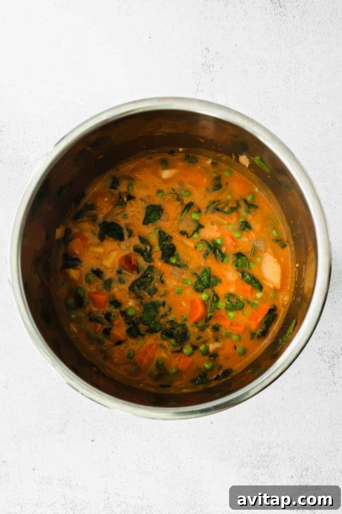 A close-up shot of creamy pumpkin curry in an Instant Pot, showcasing the rich texture and colorful vegetables.