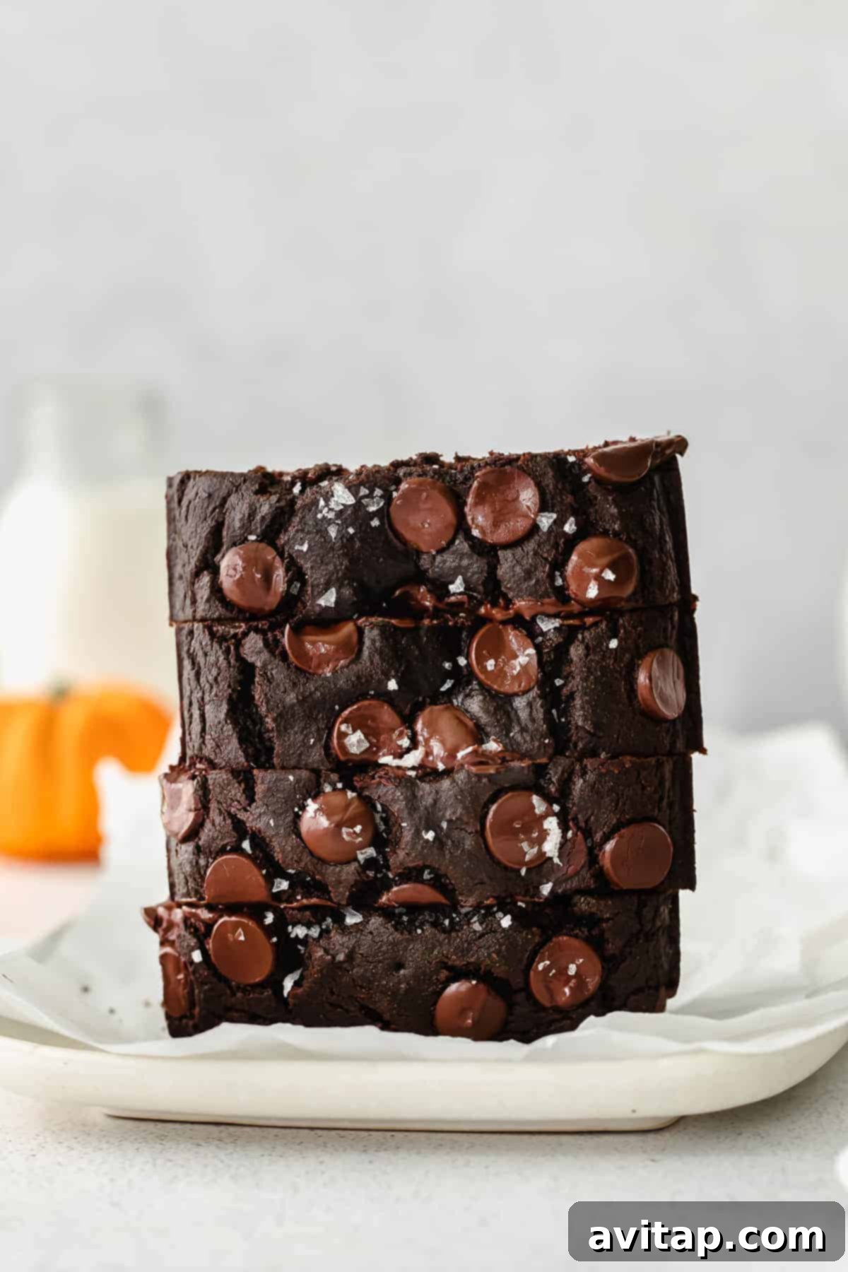 A stack of perfectly baked chocolate pumpkin bread slices, ready to be enjoyed.