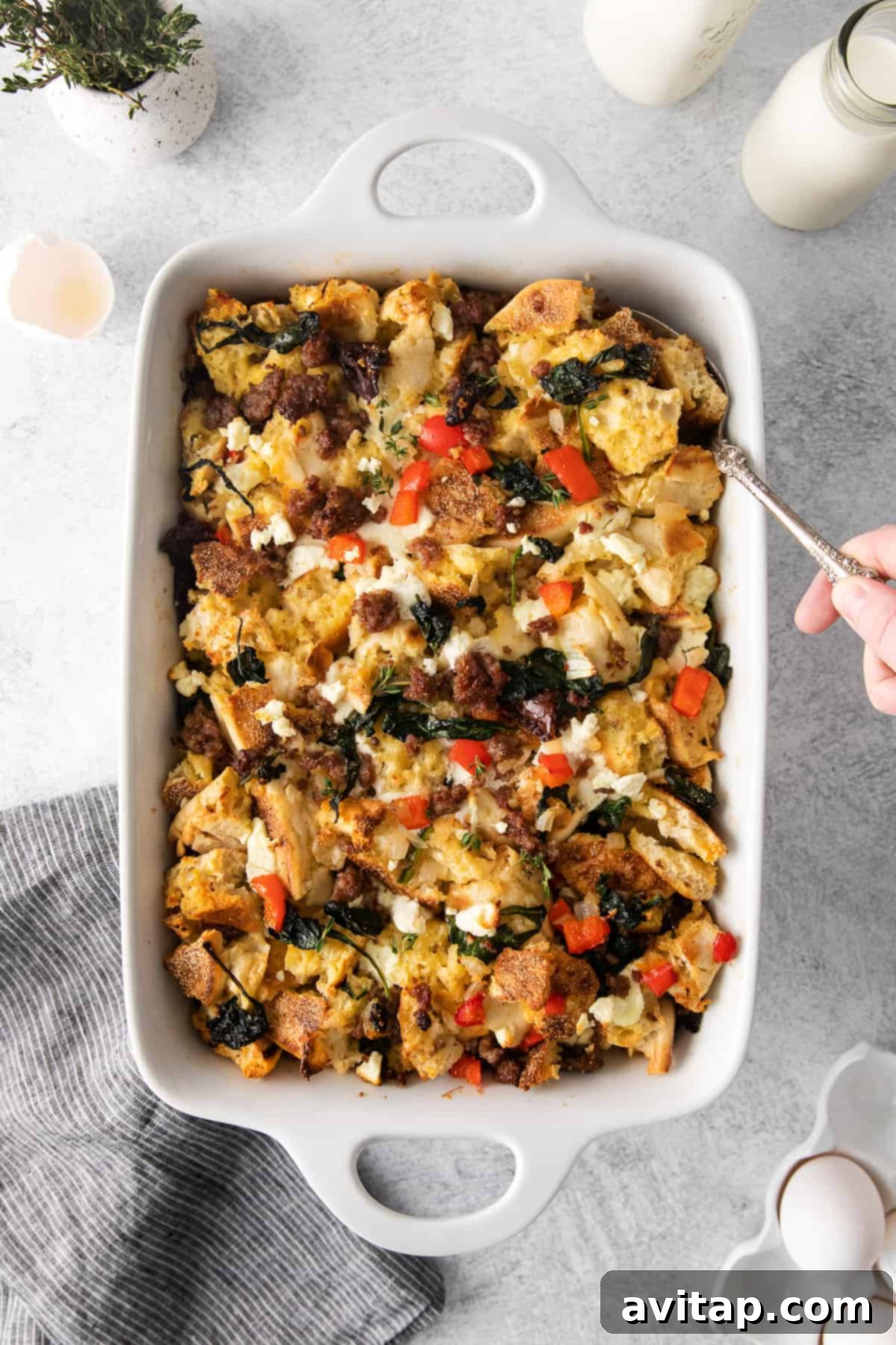 Golden brown English muffin breakfast bake in a casserole dish, ready to serve.