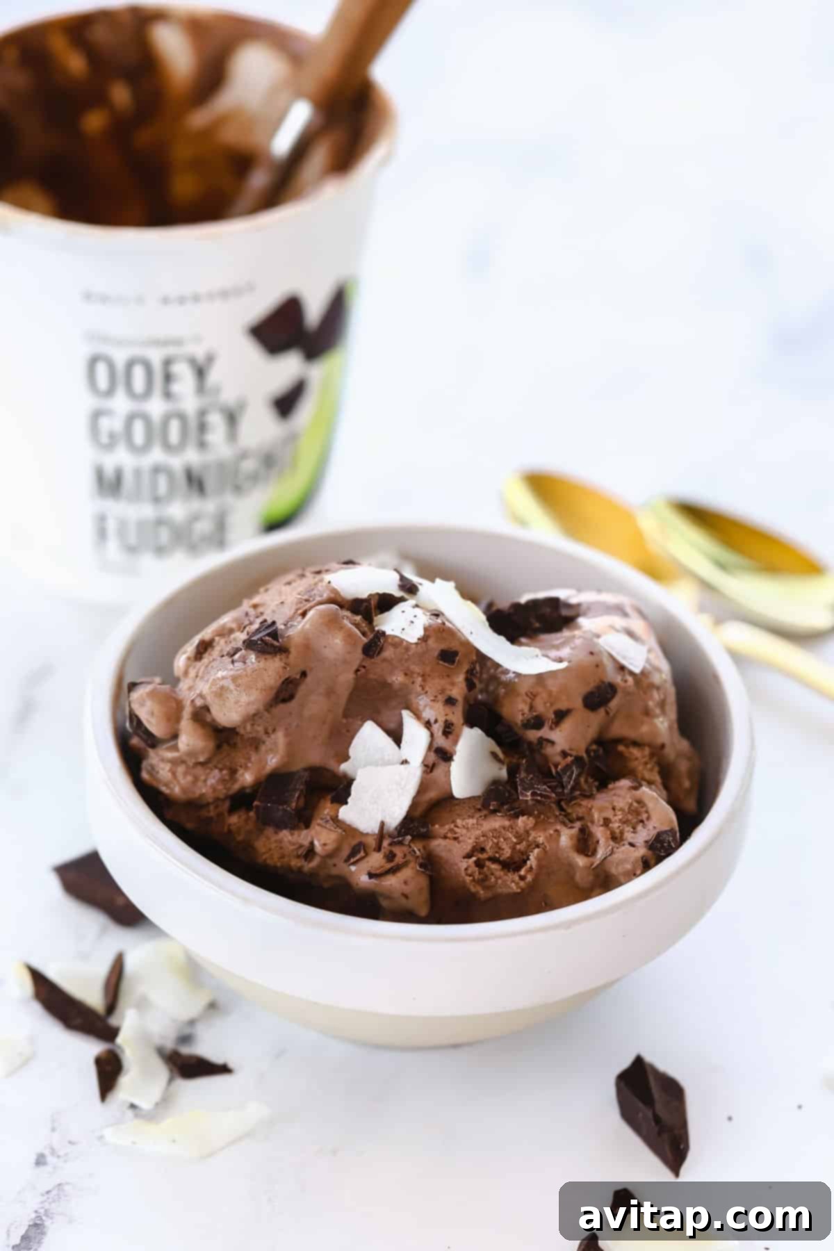 Daily Harvest ice cream in a bowl topped with coconut shreds and chunks of chocolate