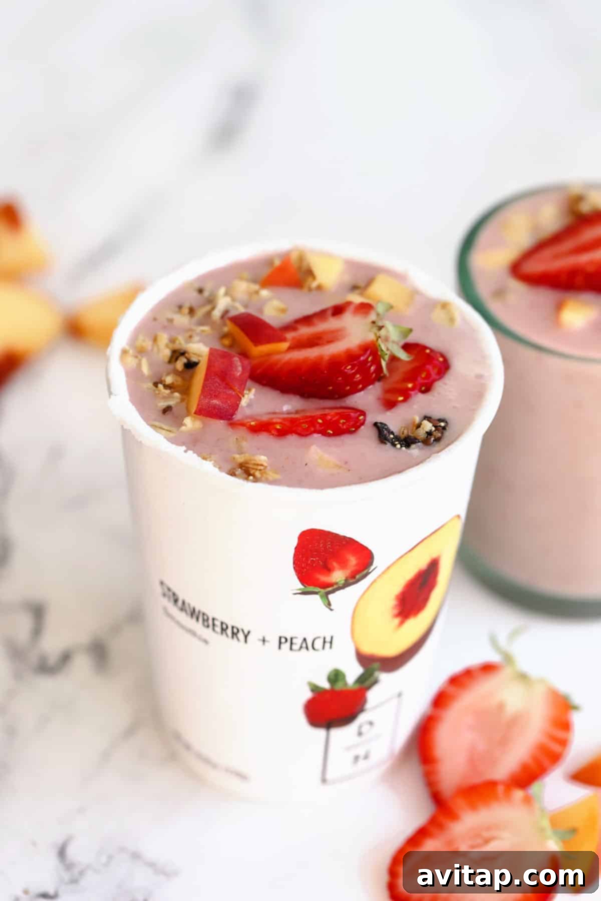 finished Daily Harvest smoothie in a cup, topped with fresh berries, ready to enjoy