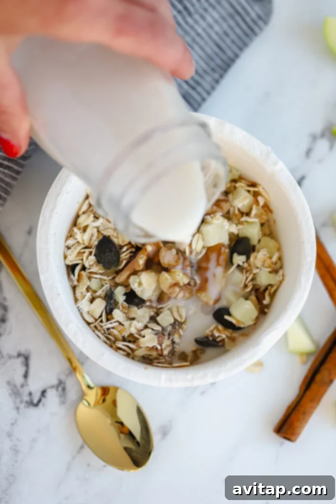 milk being poured over a Daily Harvest oat bowl, ready for mixing