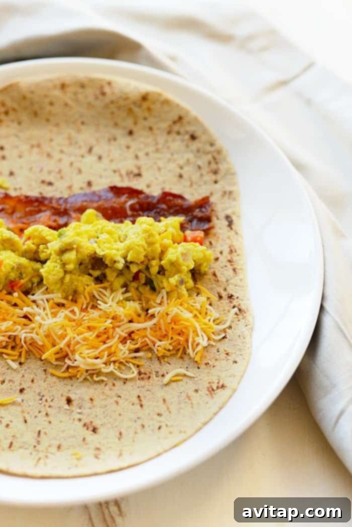 A perfectly rolled protein-packed breakfast burrito, showcasing the delicious filling and golden-brown tortilla.