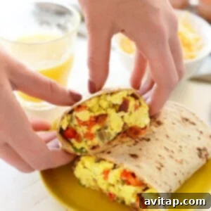 a person is preparing a nutritious burrito with eggs.