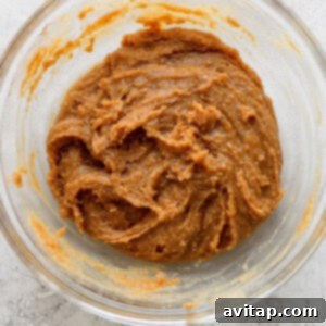 A glass bowl with a mixture of peanut butter cookie dough, chilling in the refrigerator.