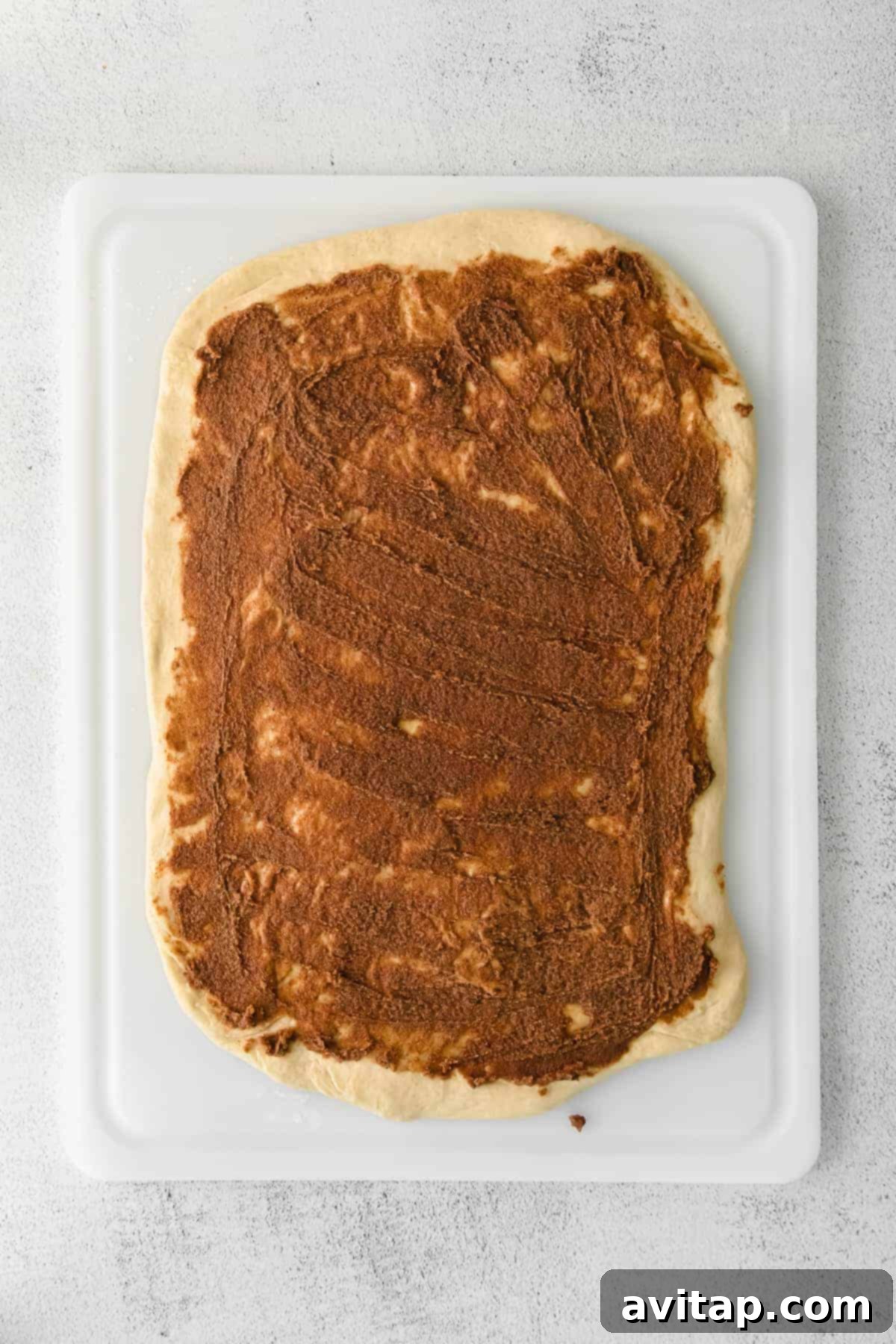 filling for maple cinnamon rolls spread evenly on the dough