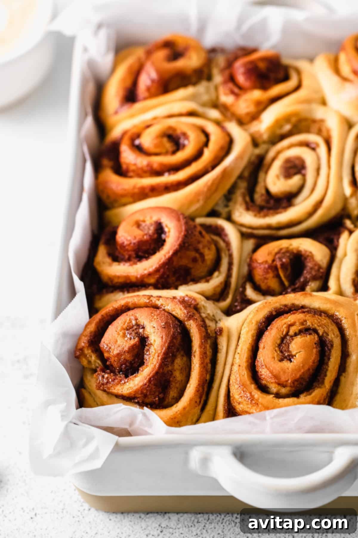 maple cinnamon rolls after being baked, fluffy and golden brown