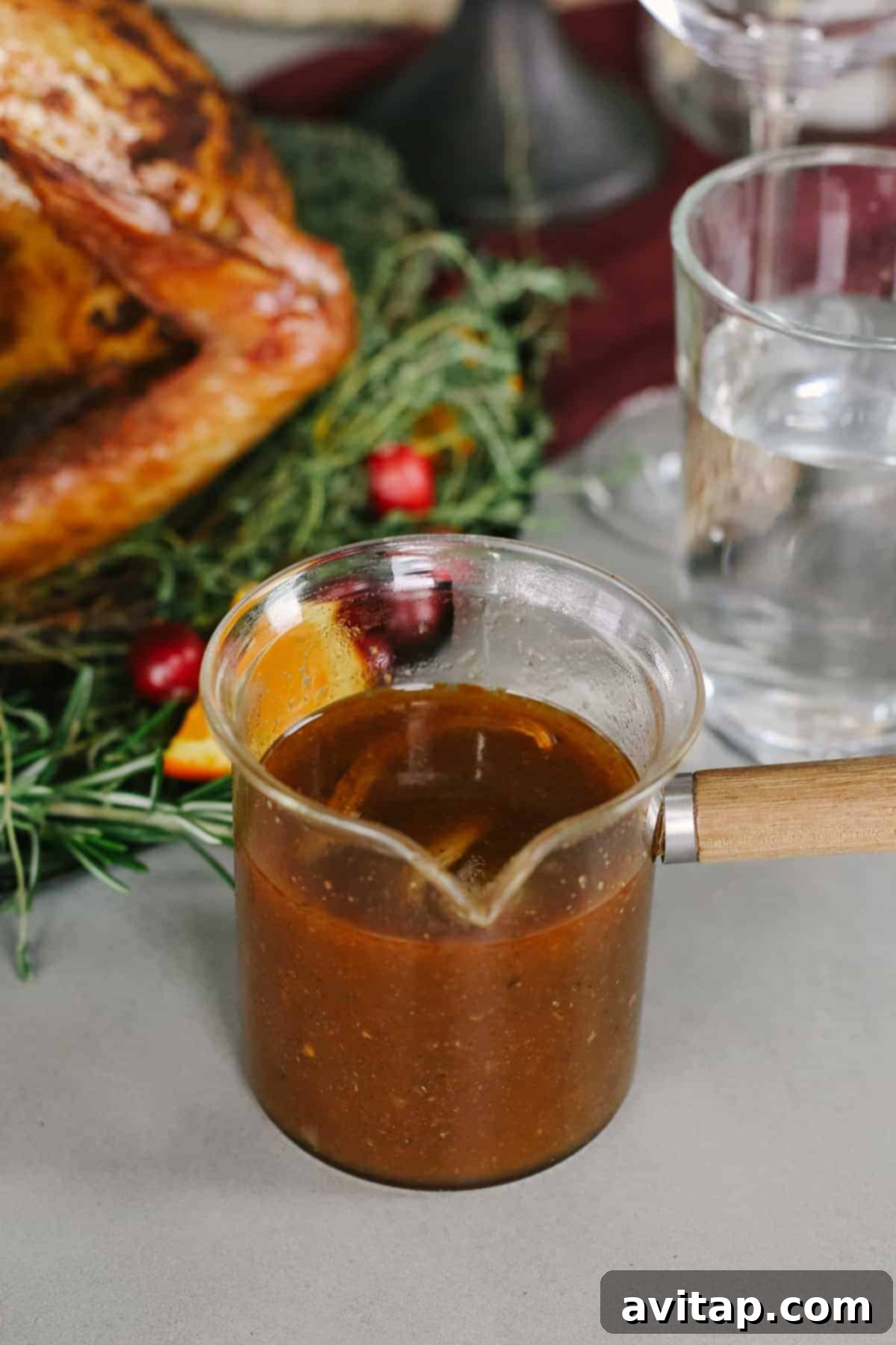 Savory Mushroom Gravy A elegant gravy boat filled with rich mushroom gravy, perfectly placed on a festive Thanksgiving table, ready to be served.