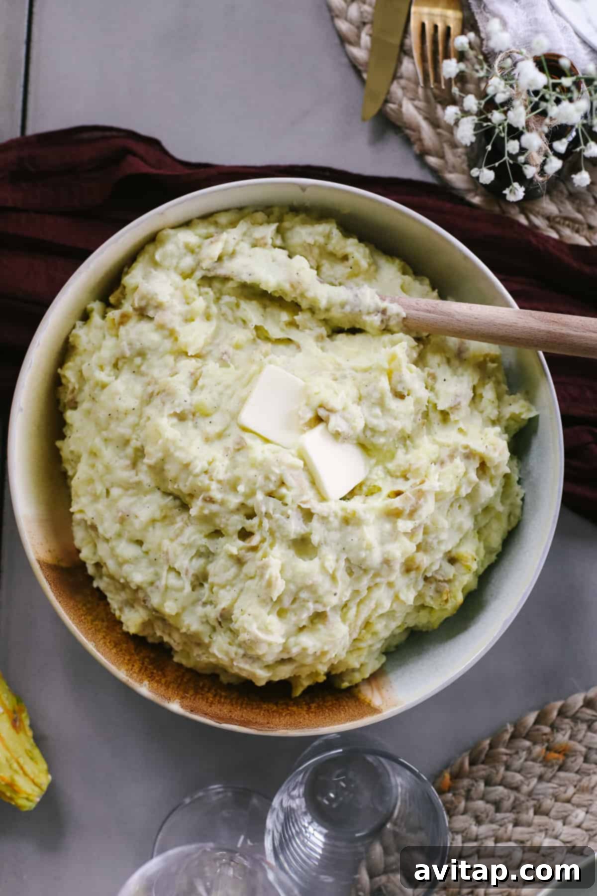 Effortless Crockpot Mashed Potatoes A large serving bowl brimming with creamy, buttery Crockpot mashed potatoes, a quintessential Thanksgiving side dish.