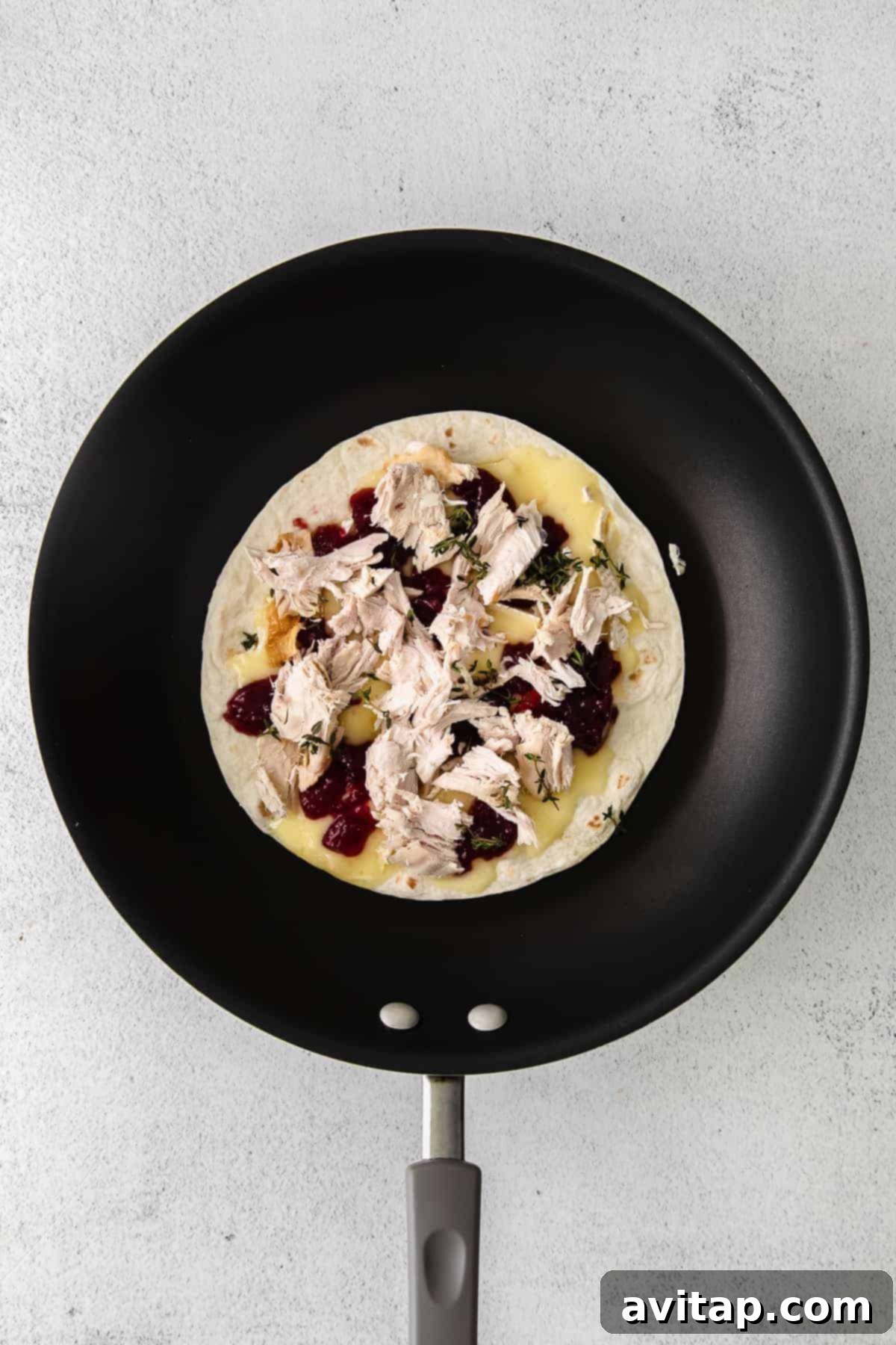 leftover thanksgiving turkey quesadilla in a skillet