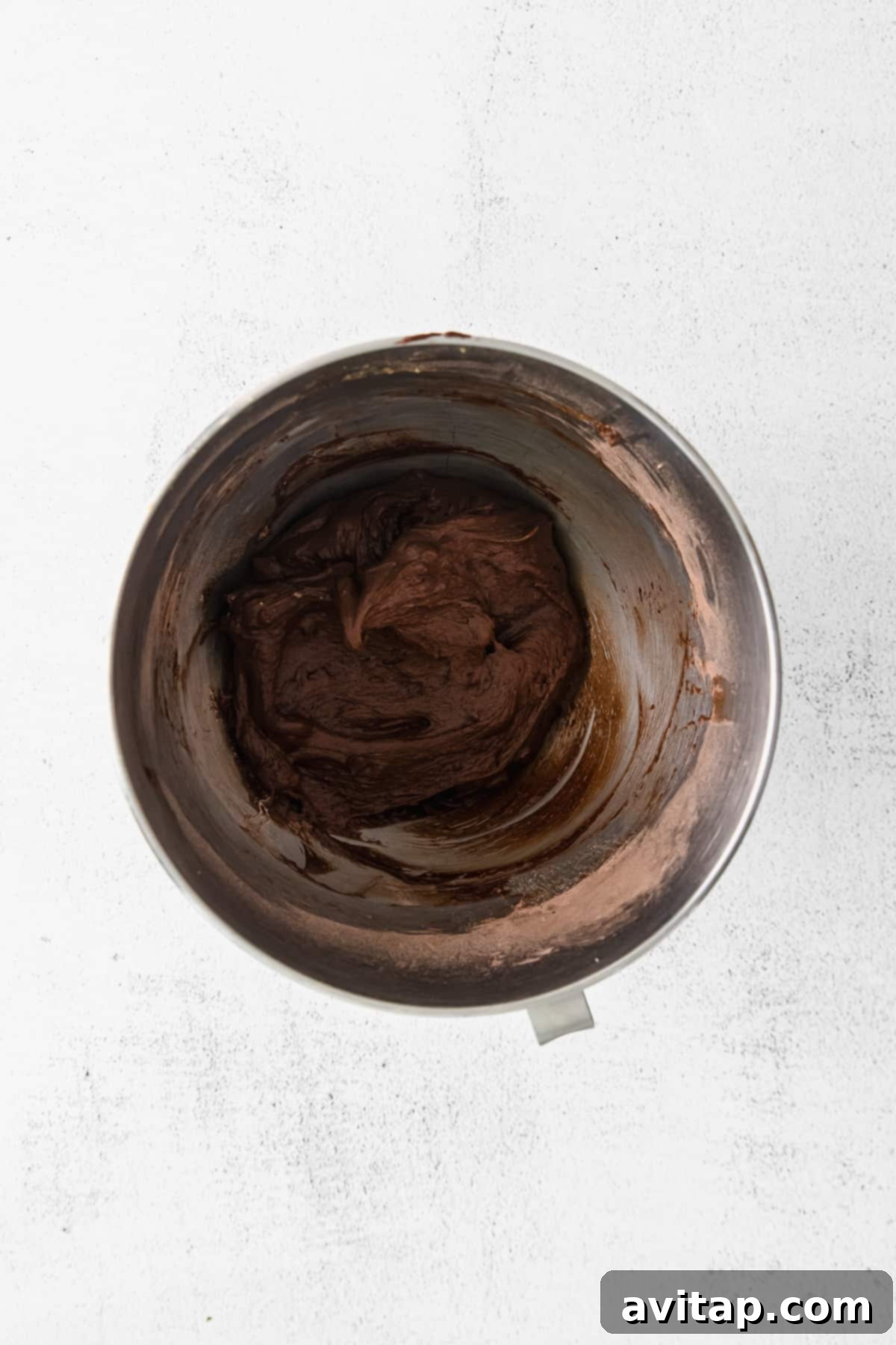 Chocolate Crinkle Cookie Dough in a Stand Mixer Chocolate cookie dough being mixed in a stand mixer, showcasing its rich, dark color and thick consistency.