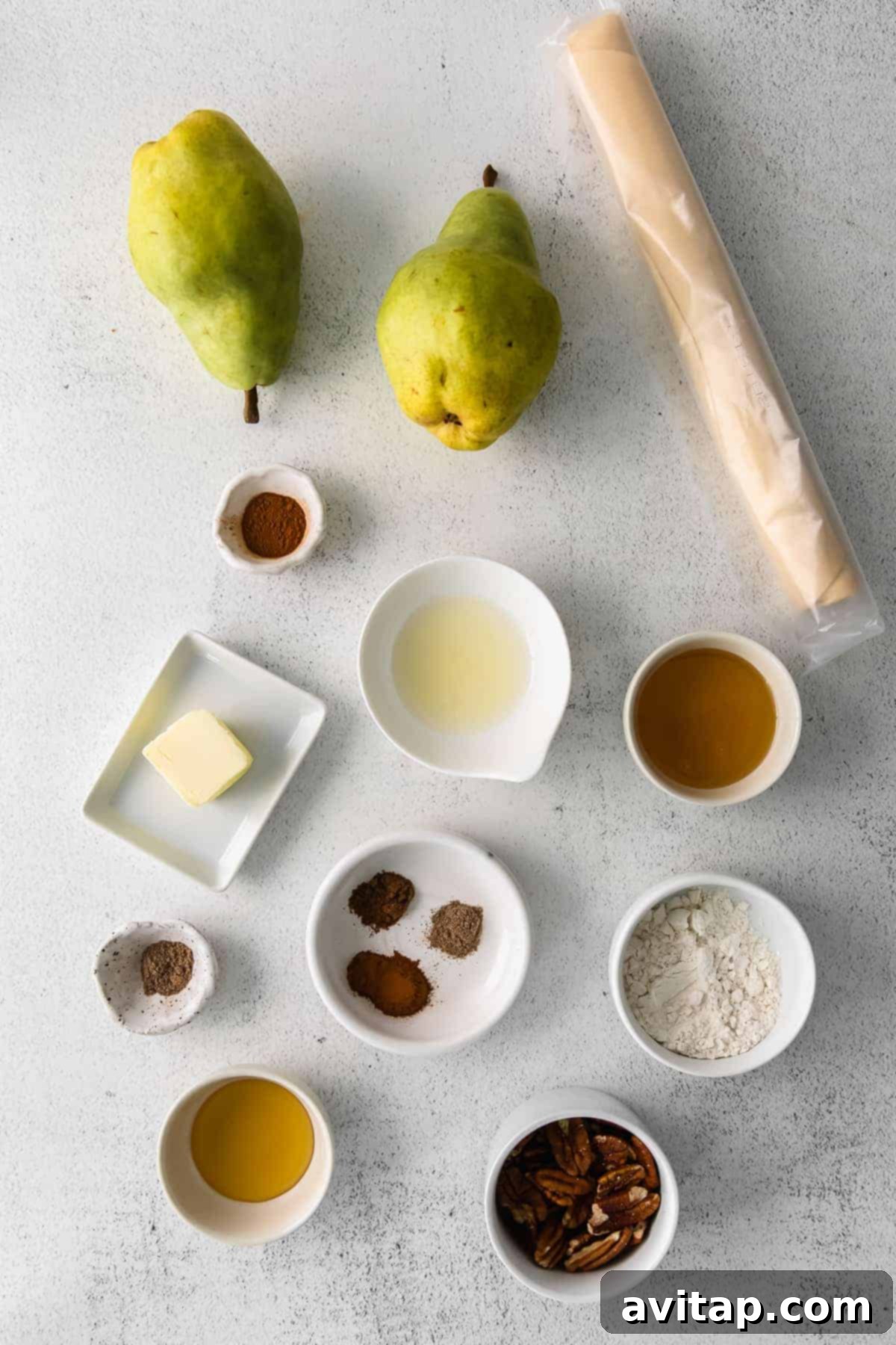 Rustic Honey-Kissed Pear Tart 3 Essential ingredients for a honey pear galette, including pears, spices, and pecans.