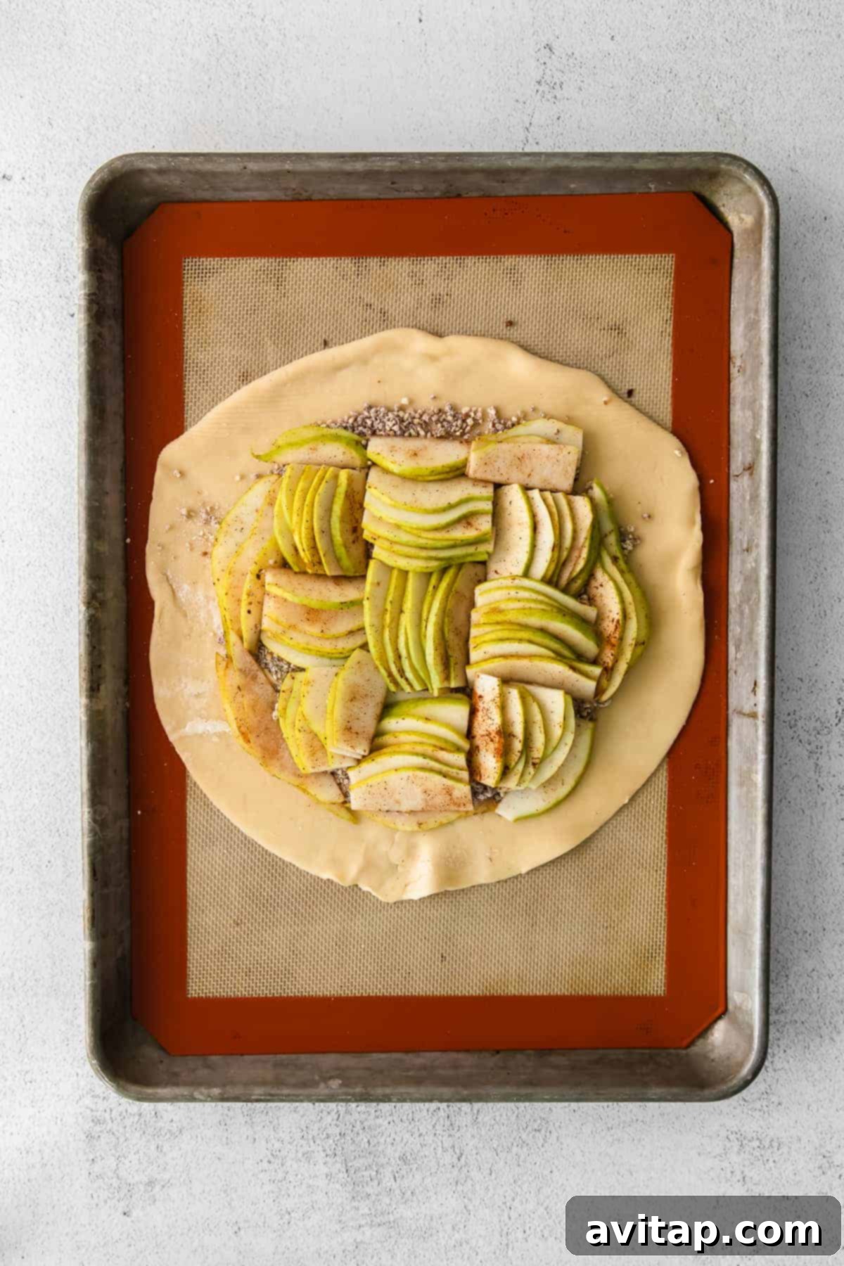 Rustic Honey-Kissed Pear Tart 6 Arranged pear slices in the center of a pie crust, ready to be folded and baked.