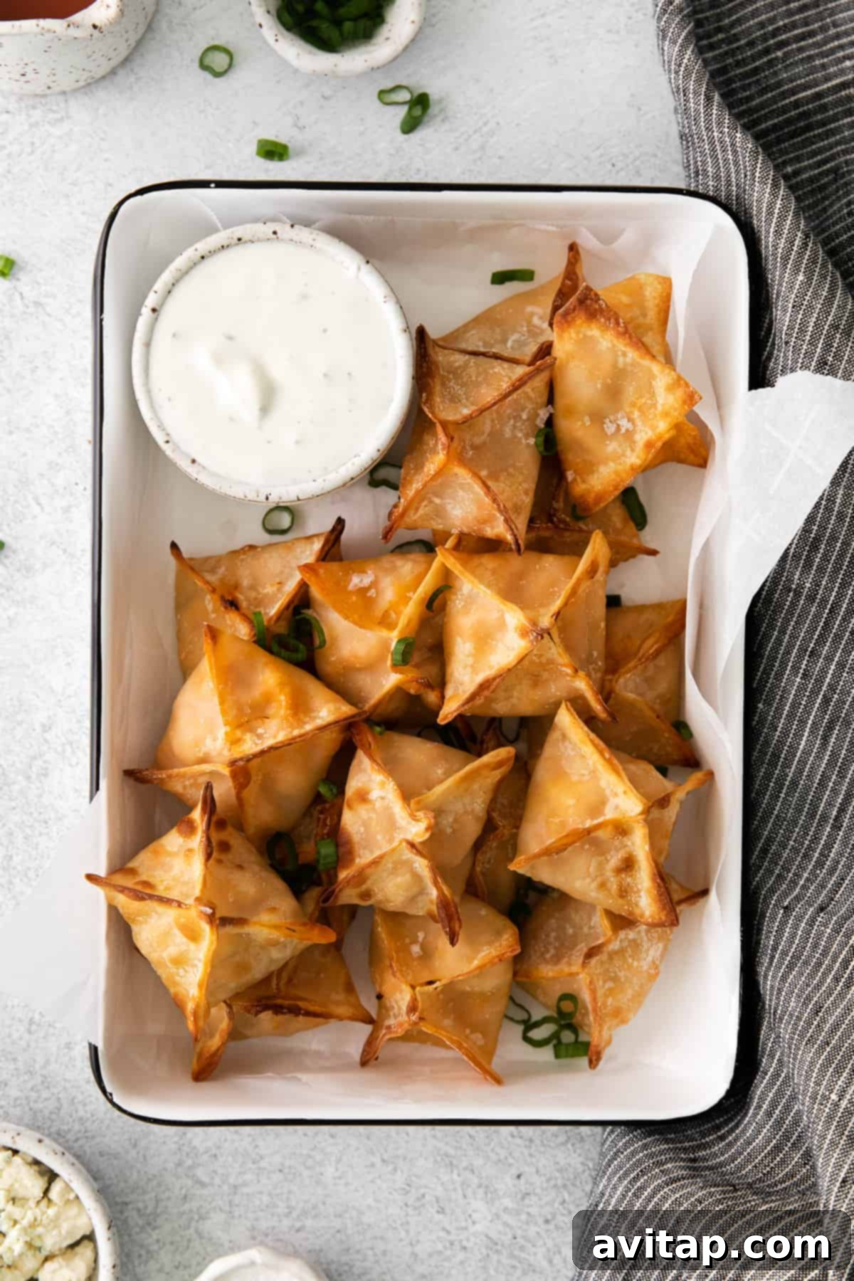 Crispy Air Fryer Buffalo Chicken Wontons served in a stylish container, ready for your next party.