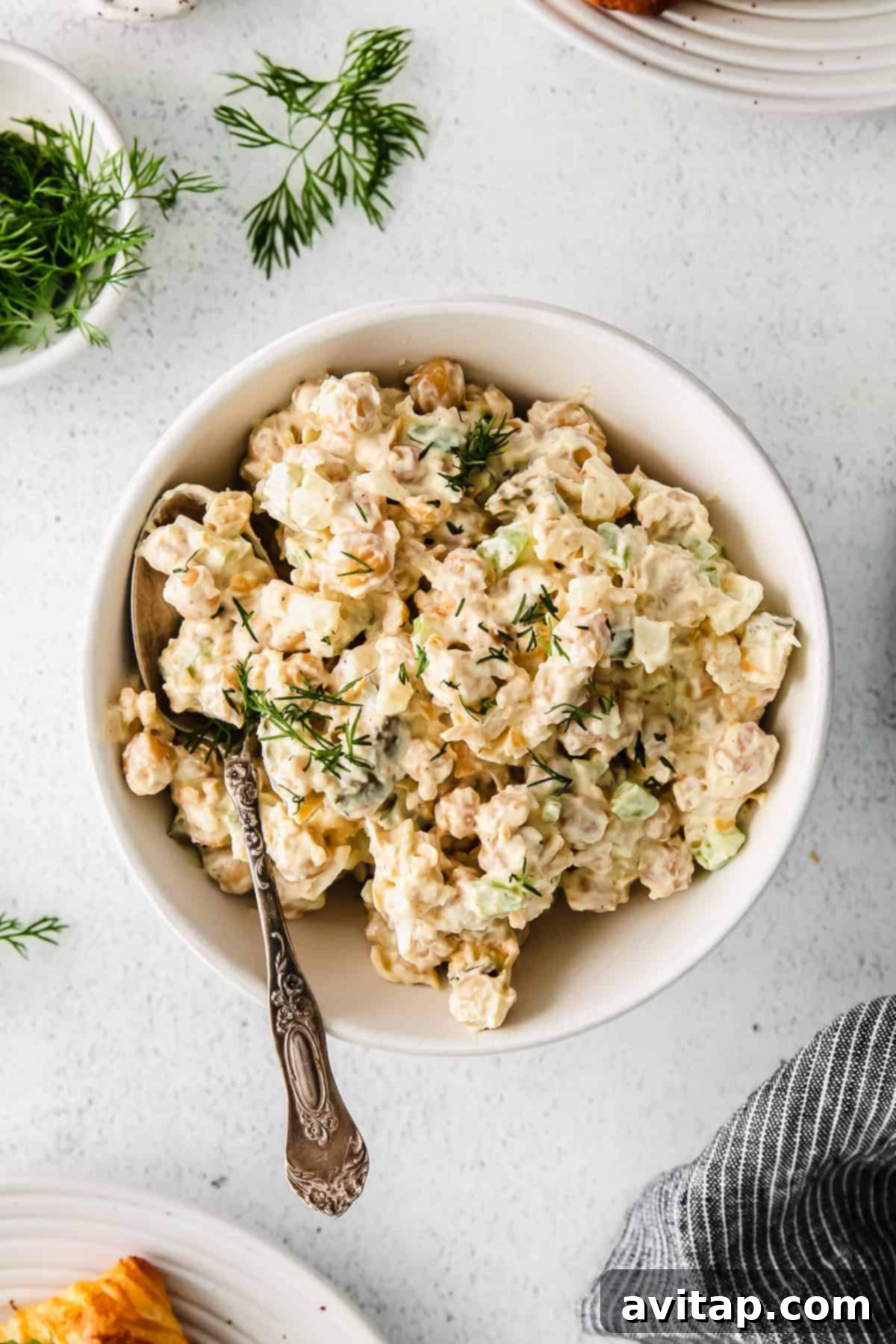 A smaller bowl of chickpea salad, beautifully presented and perfect for a single serving or as part of a larger meal spread with various accompaniments.