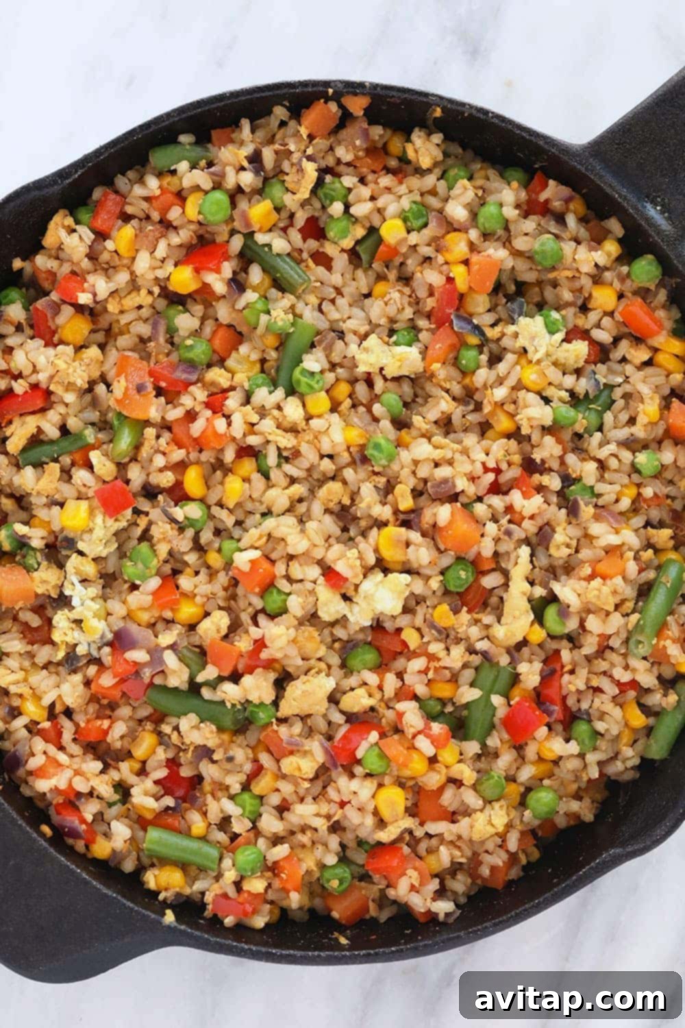 Close-up of healthy fried rice simmering in a large pan, ready to be served.