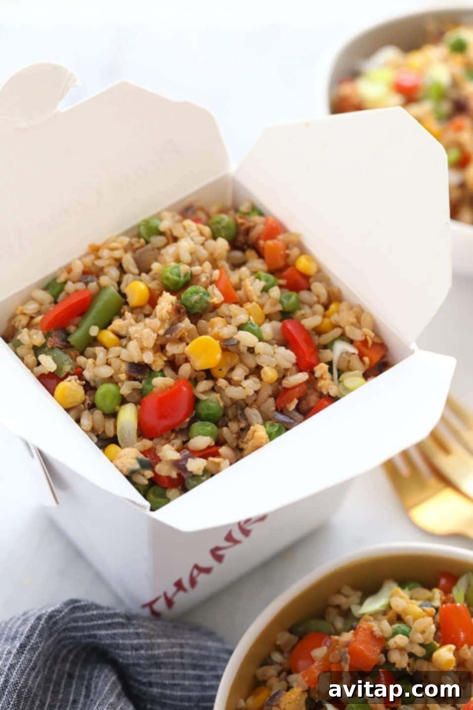 Healthy fried rice served in a classic take-out container, ready to eat.