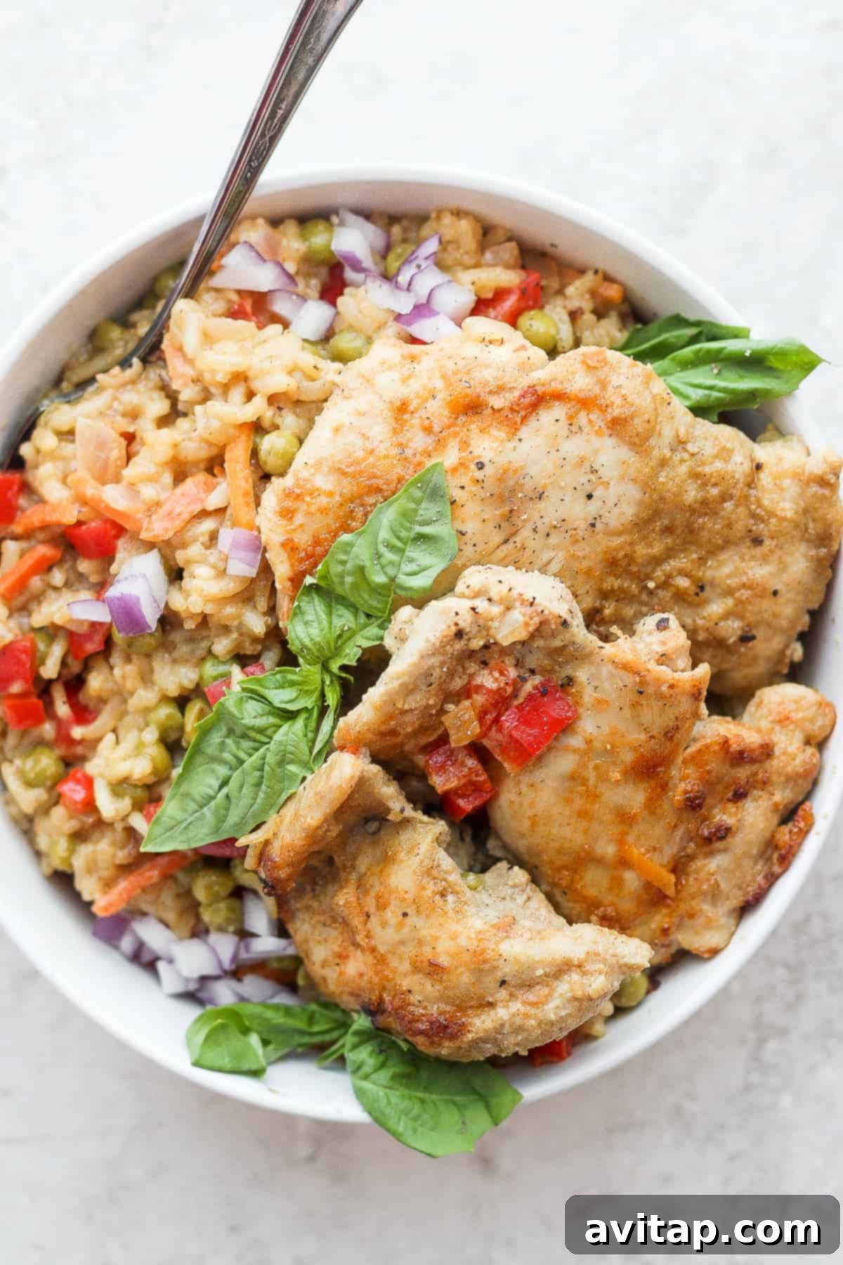 Perfectly seared and seasoned chicken thighs resting on a plate, ready for the one-pot curry