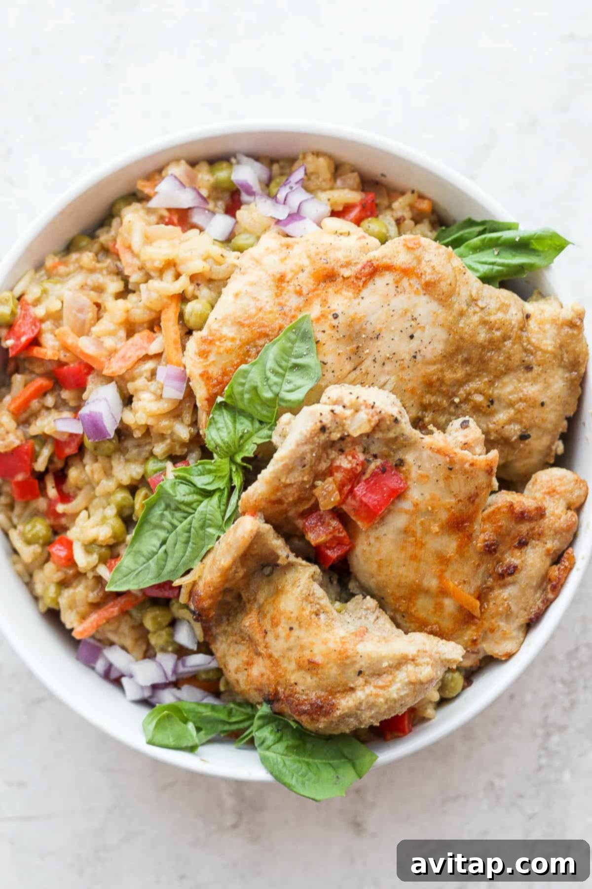 A beautifully plated serving of One-Pot Curry Chicken and Rice, garnished with fresh herbs, showcasing its rich texture and vibrant colors.