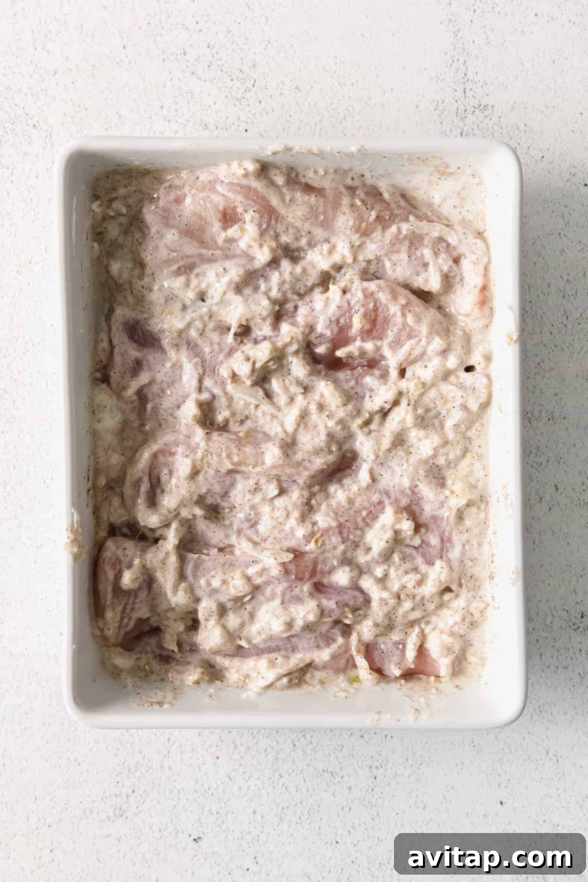 Irresistible Butter Chicken 3 Chicken thighs marinating in Greek yogurt.