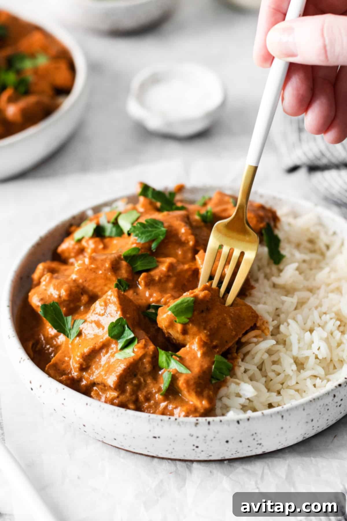Irresistible Butter Chicken 8 A fork digging into butter chicken.