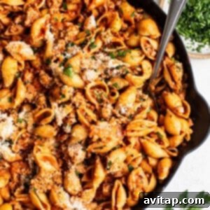 Italian Seasoning 7 A hearty ground turkey pasta dish with shells and red sauce, garnished with fresh herbs.