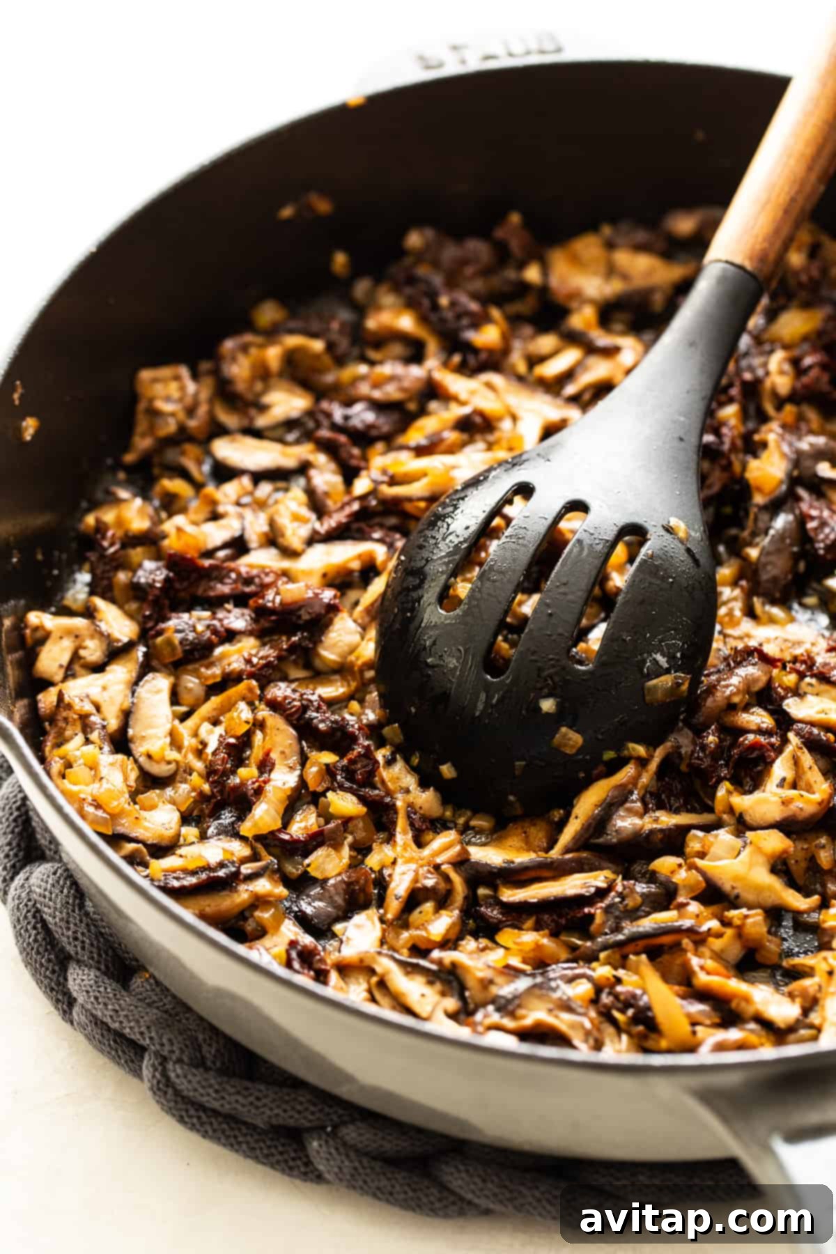 Mushrooms sautéing in a pan, ready for the chicken mushroom pasta sauce