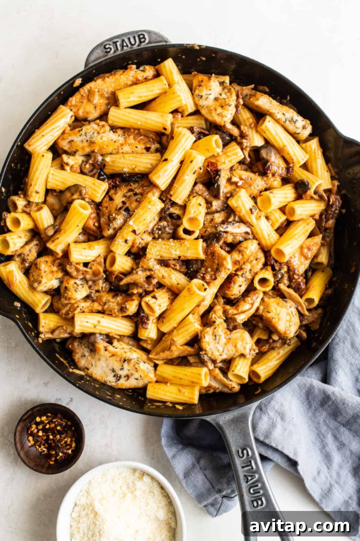 Chicken mushroom pasta tossed together in a large pan, ready to serve
