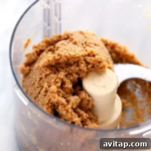 Making homemade peanut butter in a food processor to use as an ingredient for protein bars.
